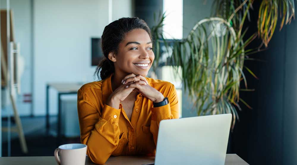 Confident professional smiling at her desk