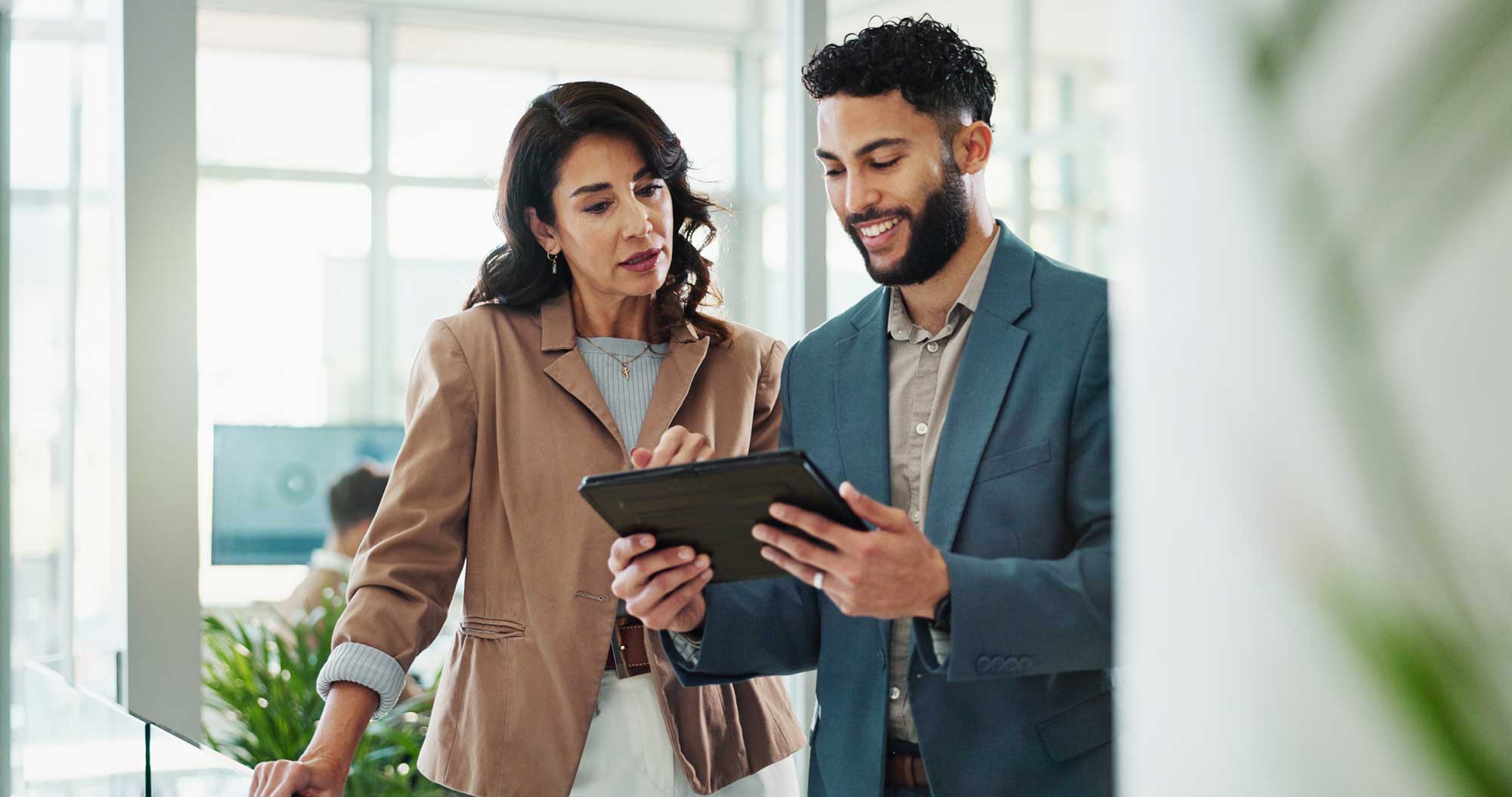 COO reviewing operations on a tablet with a colleague